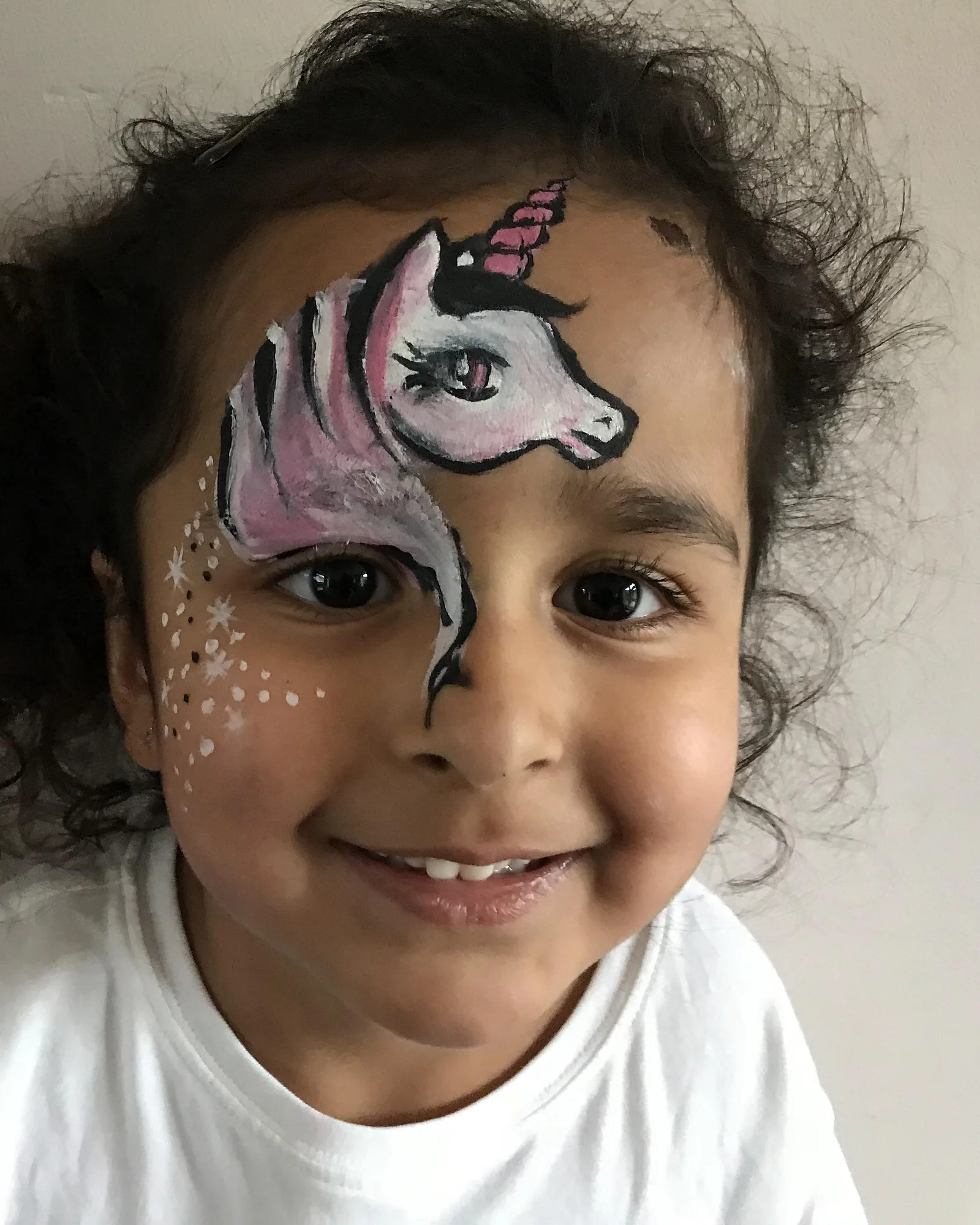 Piya's sparkle unicorn face-painting design on a child